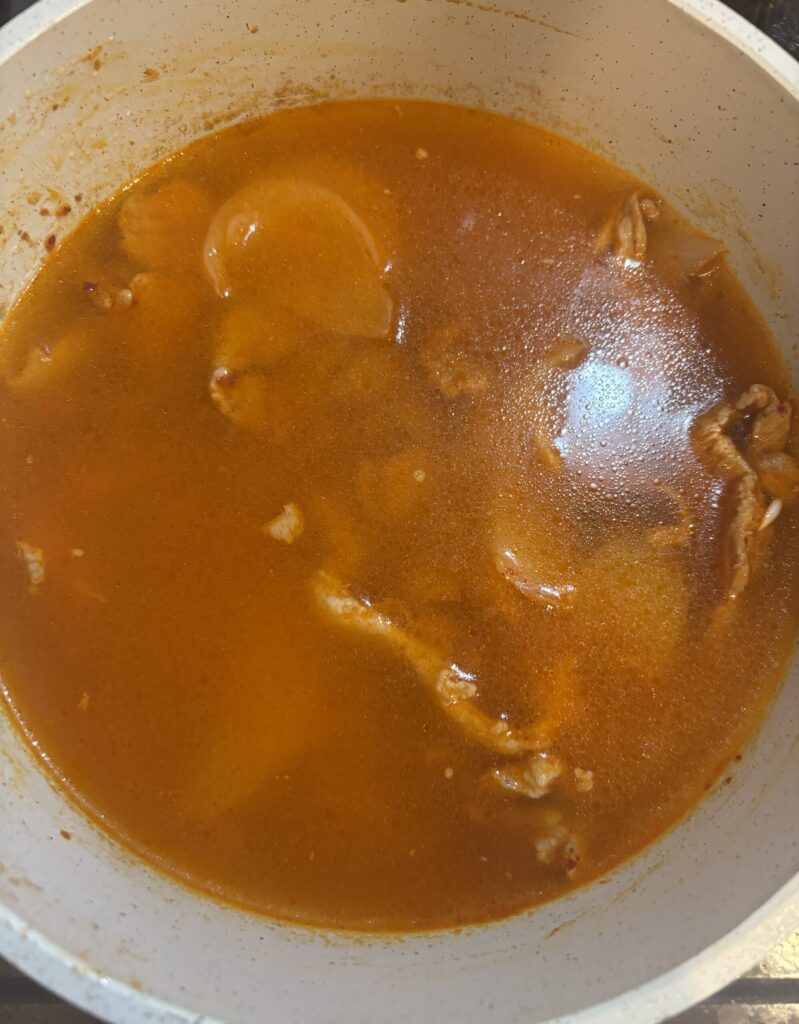 豚キムチの入った鍋に水をいれた様子